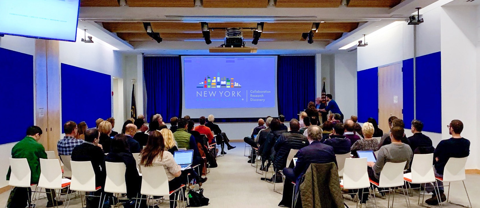 A group of NYGC affiliate members meet in a presentation space