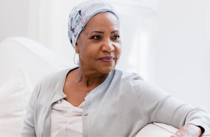 A cancer survivor wearing a head covering